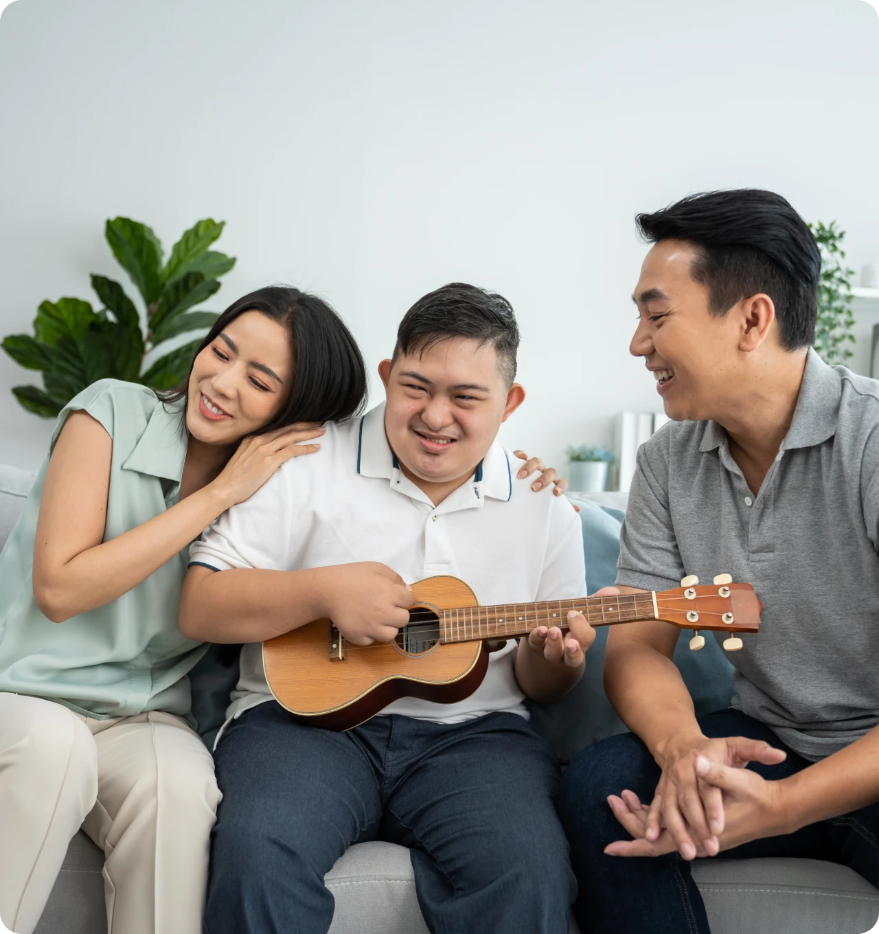 Family enjoying music together on a couch.
