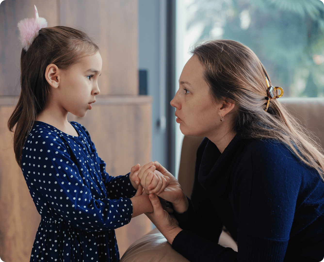 Woman and girl having a serious conversation.