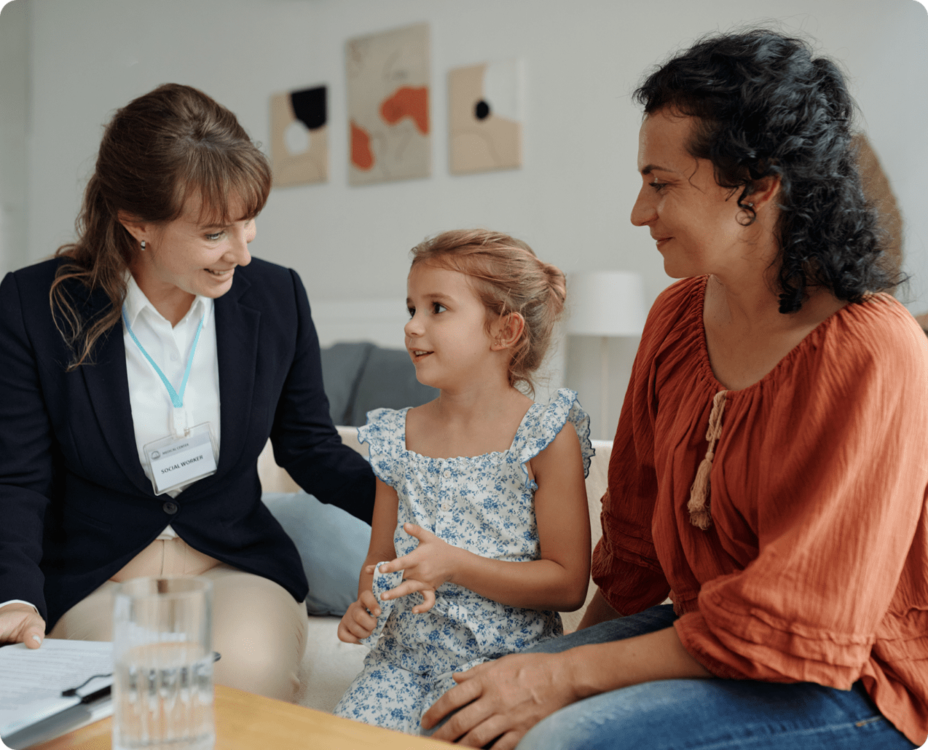 Woman, child, and professional having a conversation.