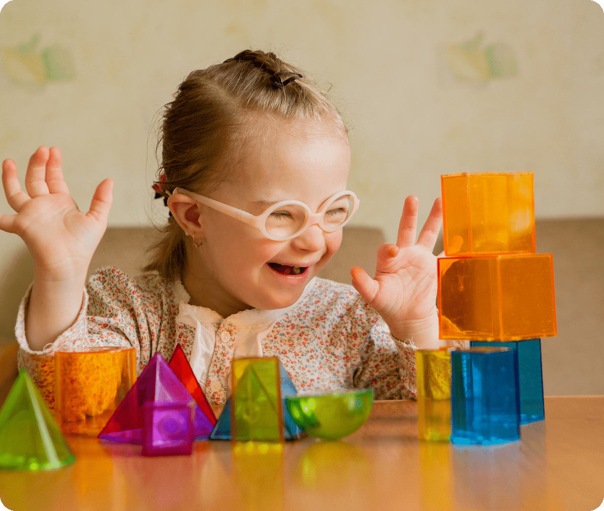 Child playing with colorful geometric blocks.